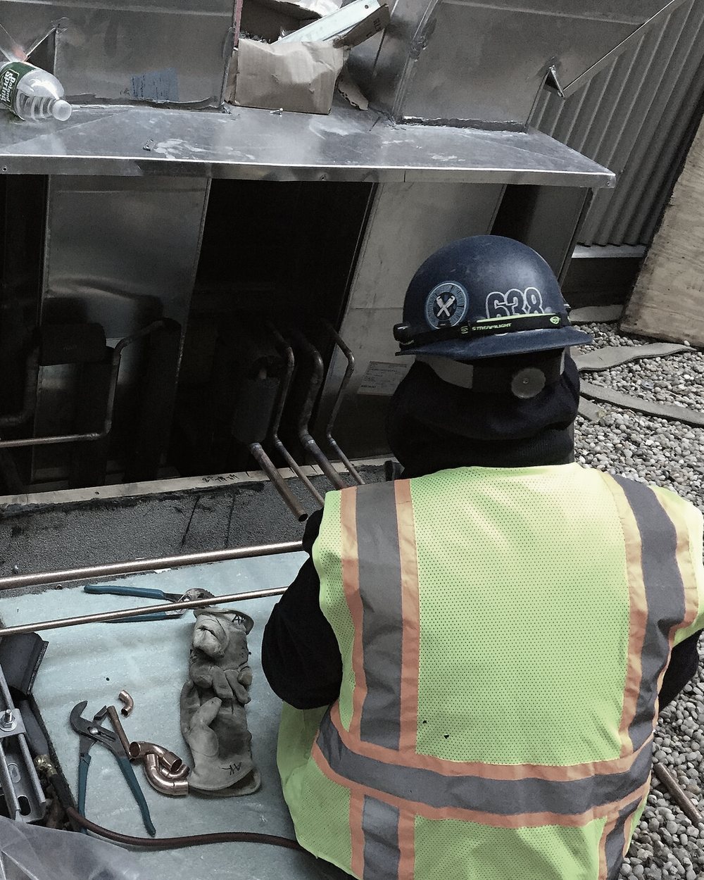 A mechanical contractor installing copper piping for rooftop air handlers.